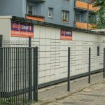 Outdoor parcel locker in Wroclaw, with Allegro Smart advertisement, near residential buildings.